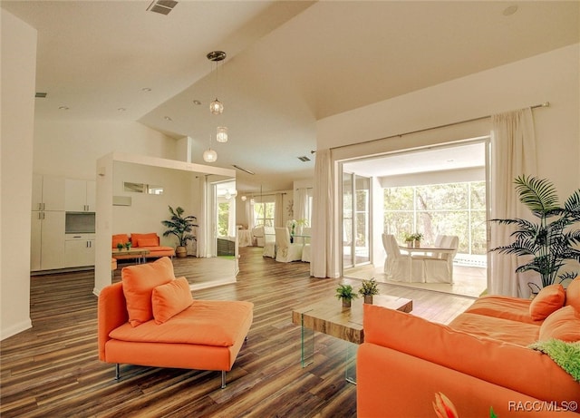 living room with high vaulted ceiling and dark wood-type flooring