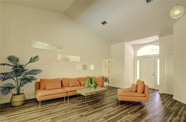 living room with high vaulted ceiling and wood-type flooring