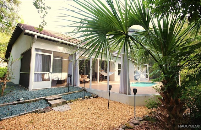 view of pool with a patio area and a sunroom