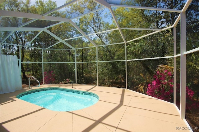 view of pool with a patio and a lanai