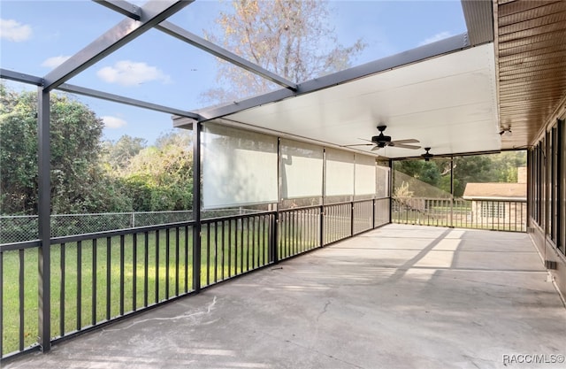 unfurnished sunroom with ceiling fan