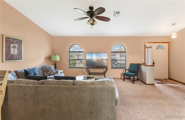 carpeted living room with vaulted ceiling and ceiling fan