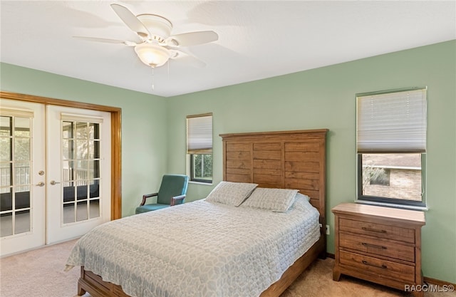 bedroom featuring french doors, access to outside, ceiling fan, and light colored carpet