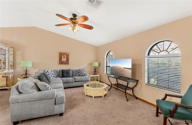 carpeted living room with ceiling fan and lofted ceiling