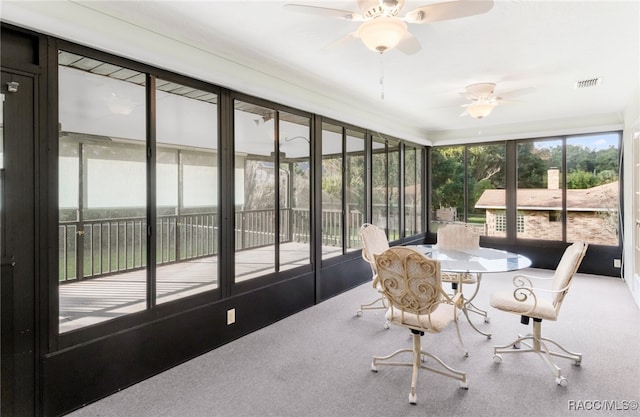 sunroom / solarium featuring ceiling fan