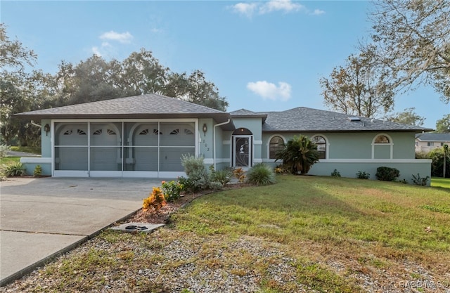 single story home featuring a front yard and a garage