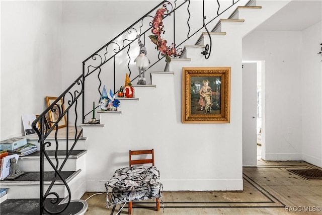 staircase with visible vents and baseboards