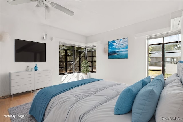 bedroom with ceiling fan and light wood-type flooring