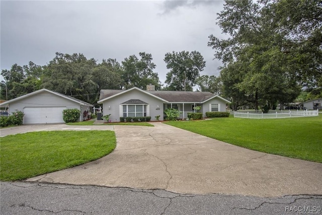 ranch-style house featuring a garage and a front yard