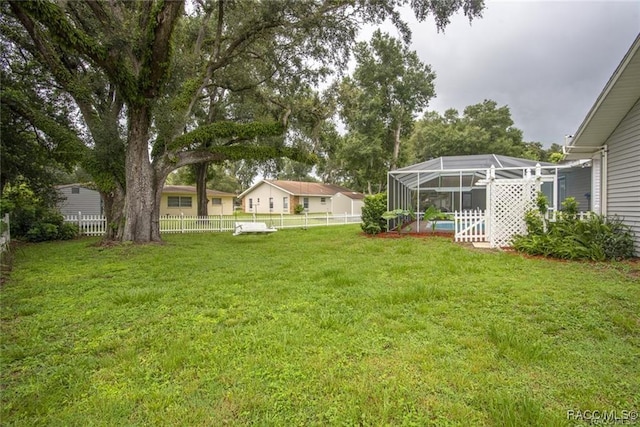 view of yard featuring glass enclosure