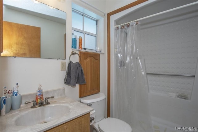 bathroom featuring vanity, curtained shower, and toilet