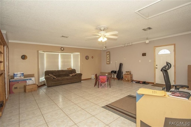 exercise room with a textured ceiling, ceiling fan, and crown molding