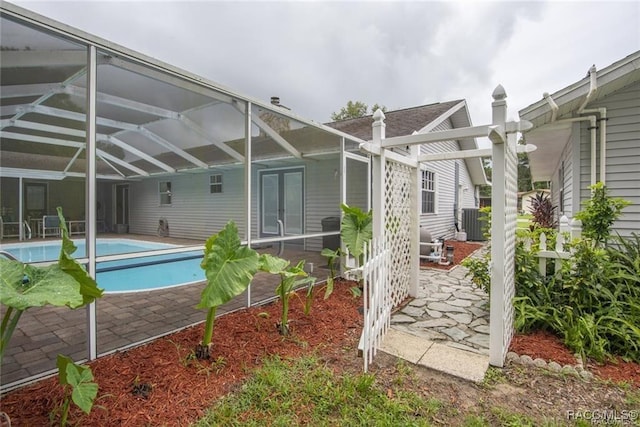 back of property with a lanai and a patio area