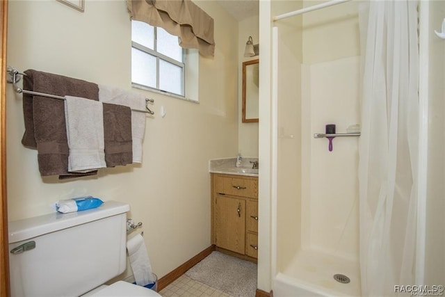 bathroom featuring walk in shower, vanity, and toilet