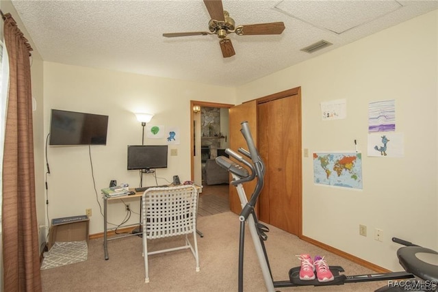 carpeted office space with ceiling fan