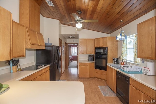 kitchen featuring ceiling fan, sink, black appliances, light hardwood / wood-style flooring, and hanging light fixtures