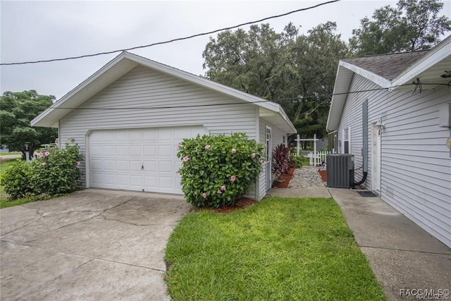 view of home's exterior featuring a garage and cooling unit