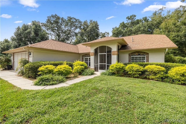 view of front facade with a front lawn and a garage