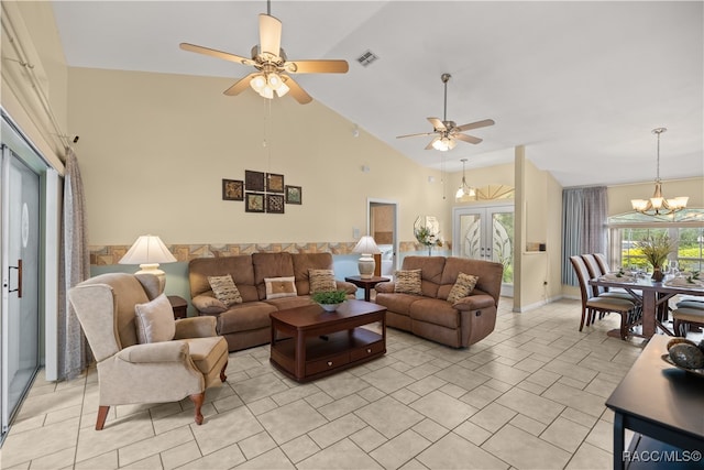 tiled living room with french doors, high vaulted ceiling, and ceiling fan with notable chandelier