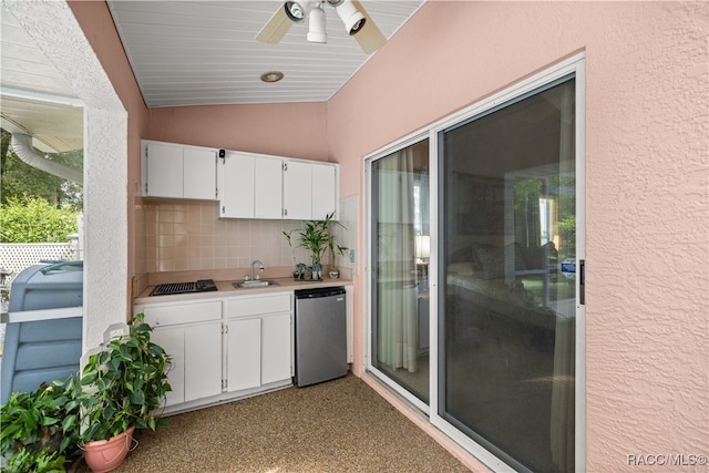 exterior space with ceiling fan, sink, and an outdoor kitchen