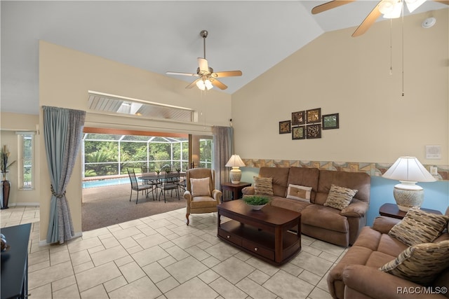 living room with ceiling fan, high vaulted ceiling, and light colored carpet