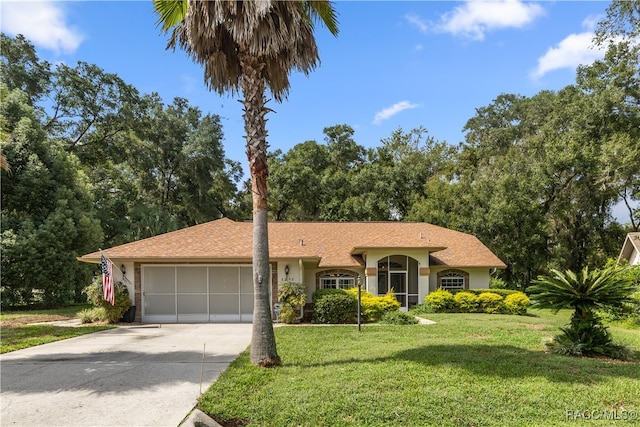 ranch-style home featuring a garage and a front lawn