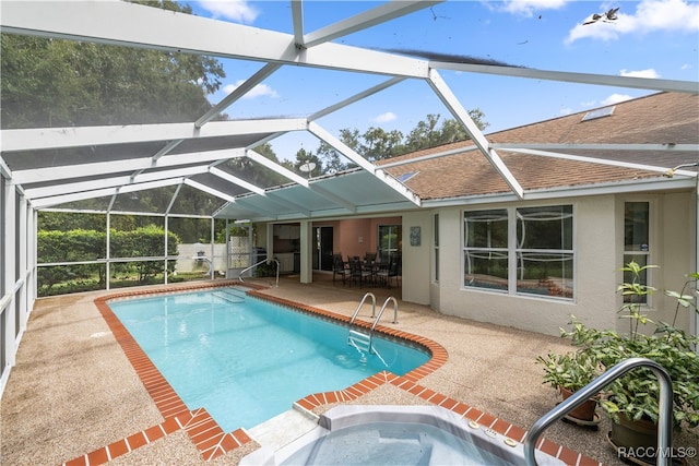 view of swimming pool with a patio area and glass enclosure