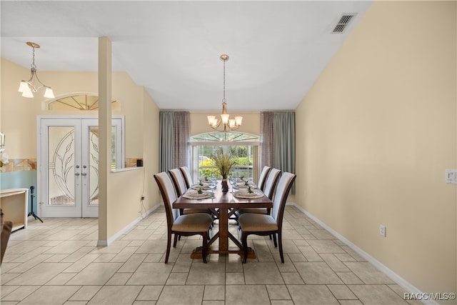 dining space featuring french doors and an inviting chandelier