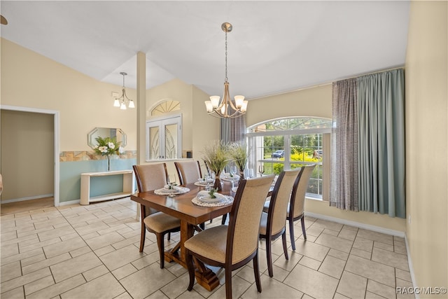 tiled dining area featuring french doors and an inviting chandelier