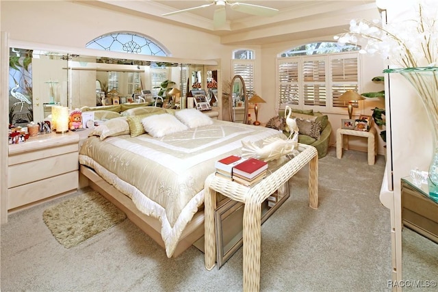 carpeted bedroom featuring ceiling fan and crown molding