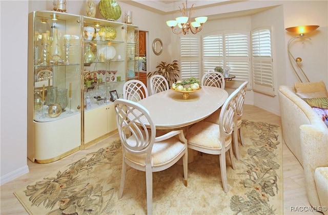 dining space featuring ornamental molding and an inviting chandelier