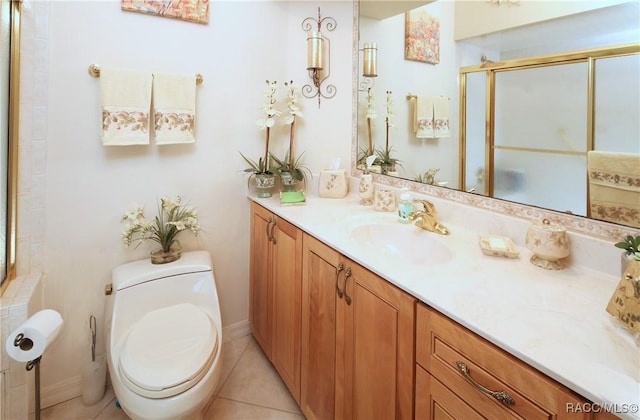 bathroom with tile patterned flooring, vanity, toilet, and walk in shower