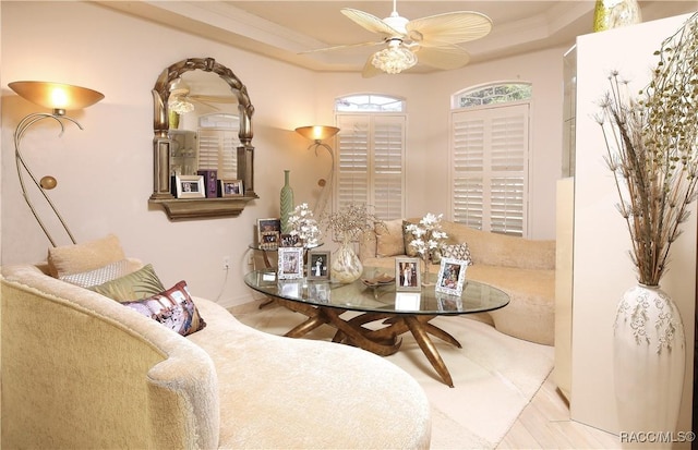 dining space featuring ceiling fan, ornamental molding, and a tray ceiling