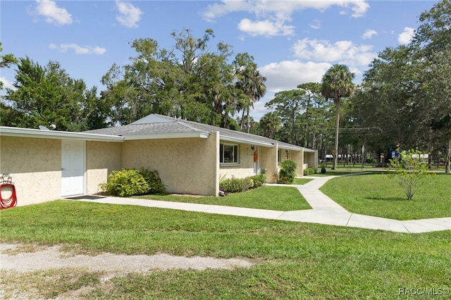 view of property exterior with a yard and stucco siding