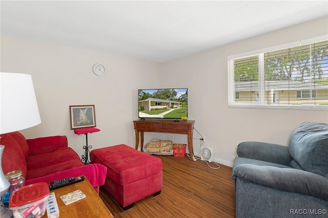 living room with baseboards and wood finished floors