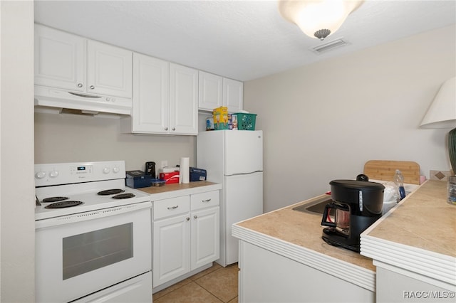 kitchen featuring light countertops, white appliances, white cabinetry, and under cabinet range hood