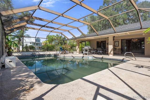 view of swimming pool featuring a patio and glass enclosure