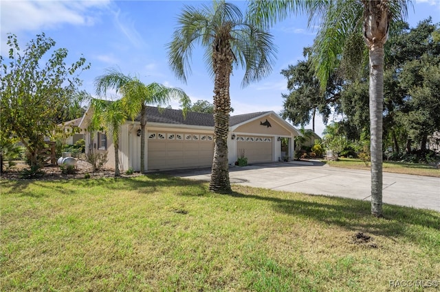 view of front of property with a front yard and a garage