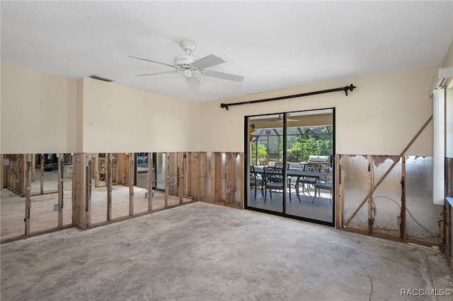 spare room featuring ceiling fan, concrete flooring, and a textured ceiling