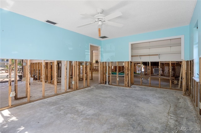 miscellaneous room with ceiling fan and concrete flooring