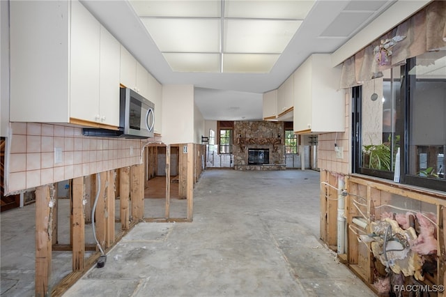 kitchen with white cabinets and a fireplace