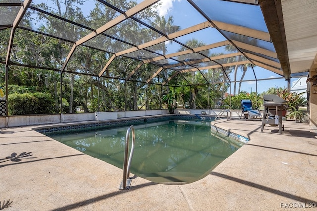 view of swimming pool with a lanai and a patio