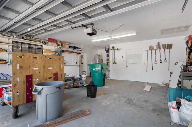 garage with a garage door opener and water heater