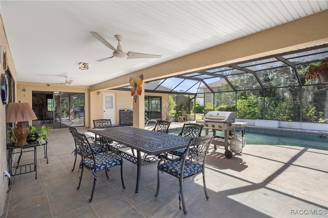 view of patio / terrace featuring area for grilling, ceiling fan, and a lanai