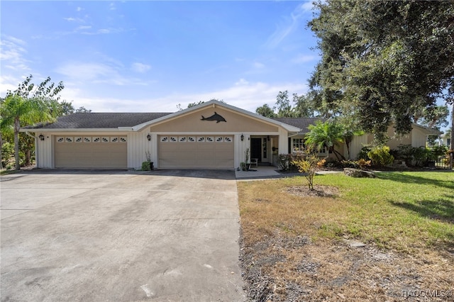 ranch-style home featuring a front lawn and a garage