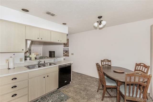 kitchen with sink, dishwasher, a notable chandelier, a textured ceiling, and light brown cabinetry