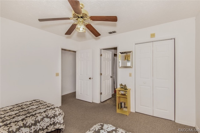 carpeted bedroom featuring a closet and ceiling fan