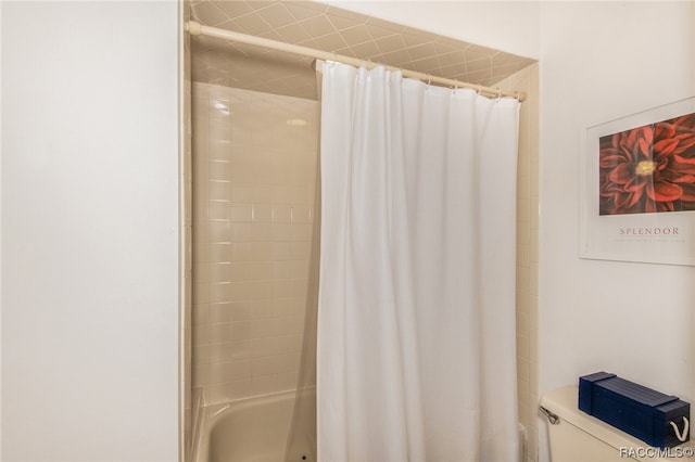 bathroom with shower / bath combo and toilet