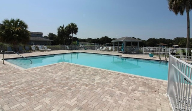 view of swimming pool with a gazebo and a patio