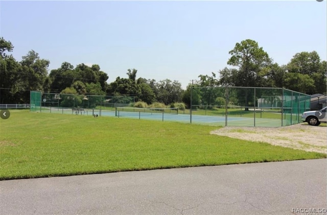 surrounding community featuring a lawn and tennis court